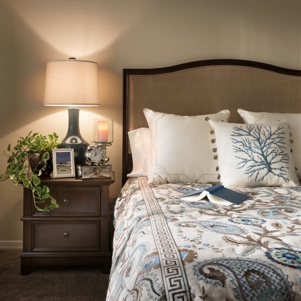 Well-decorated primary bedroom of model home at San Sonoma in Tempe, Arizona