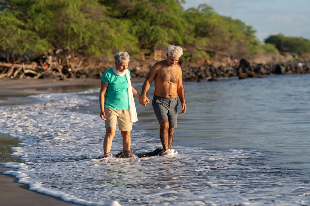 Resident couple walking on the beach near Kauai Care Center in Waimea, Hawaii