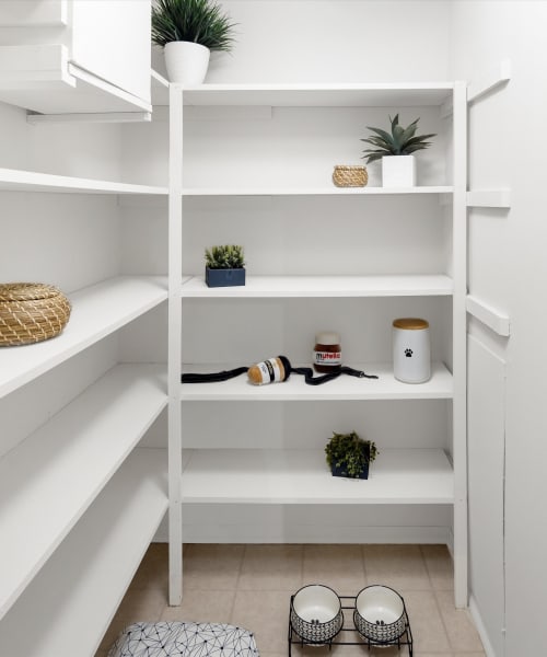 Walk-in closet with built-in shelving at Fairmont Park Apartments in Farmington Hills, Michigan