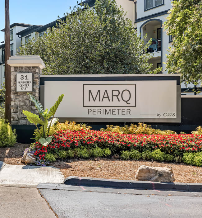 Chairs surrounding the sparkling community pool at Marq Perimeter in Atlanta, Georgia