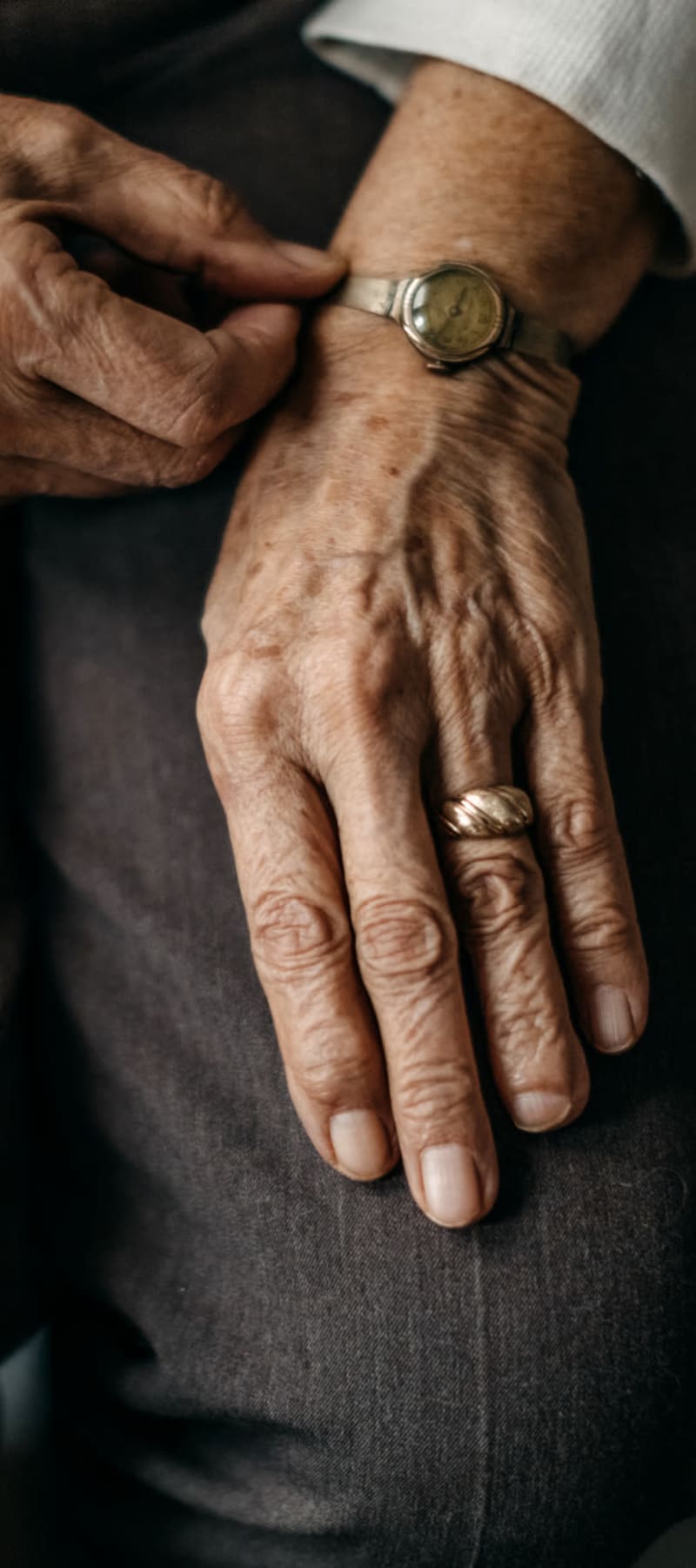 Resident at a WISH community adjusting her wrist watch