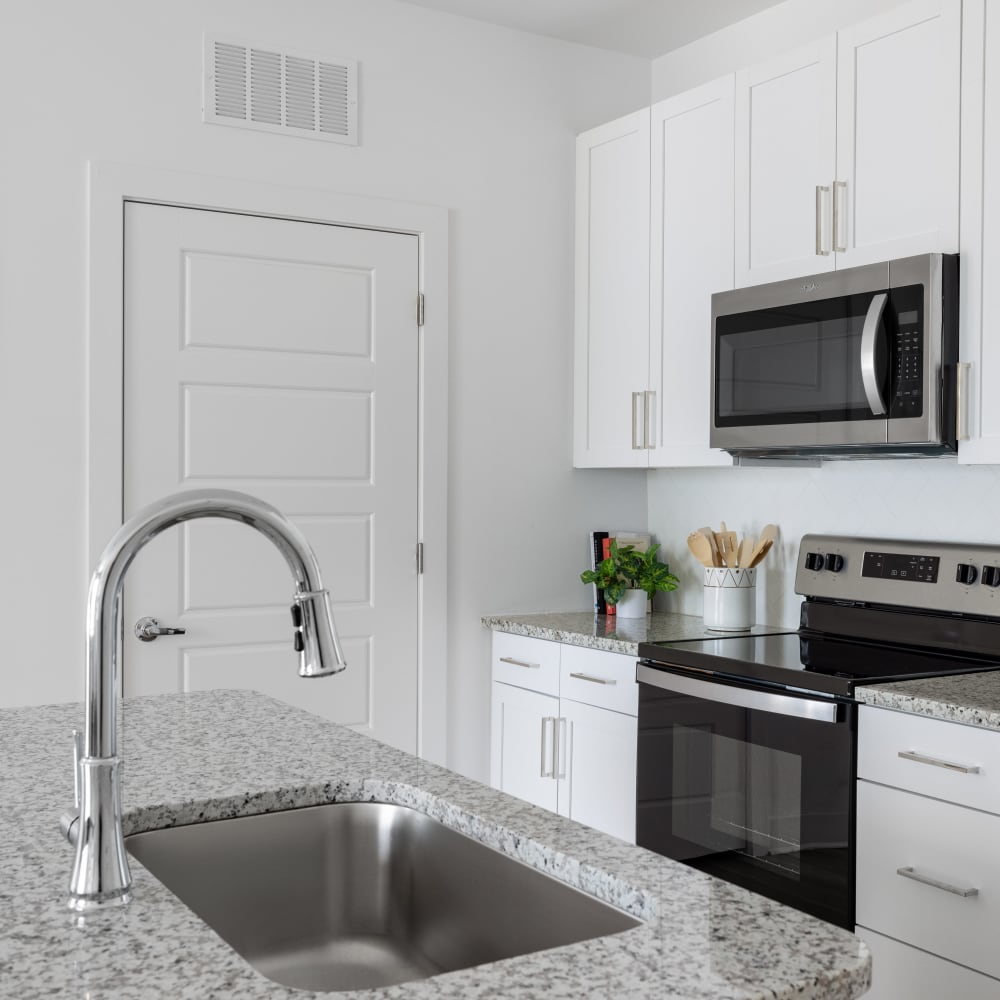 Model kitchen with stainless-steel appliances at The Archer In Acworth in Acworth, Georgia