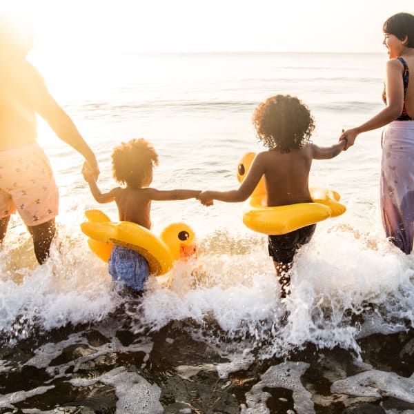 Resident children splashing in the ocean near Olympus Emerald Coast in Destin, Florida