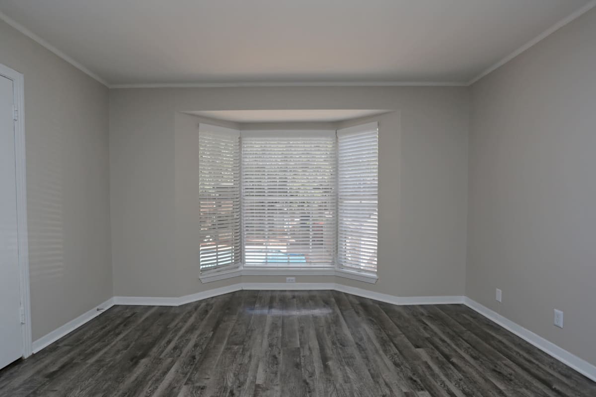 Wood-style flooring in an apartment living room at Tanglewood in San Antonio, Texas