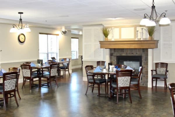 Dining hall with dark stone flooring and tall ceilings at Deephaven Woods in Deephaven, Minnesota