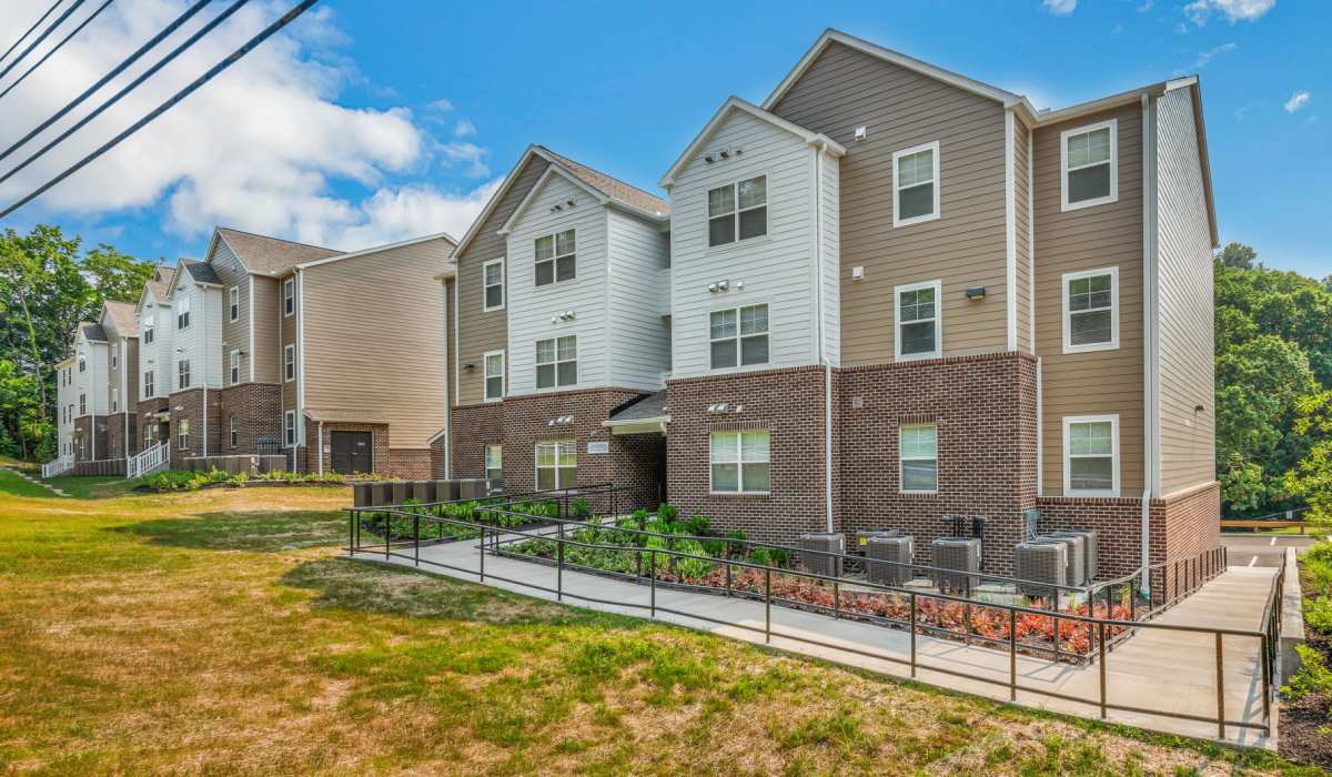 Grassy area next to exterior view of buildings at Magnolia Greene in Lavale, Maryland
