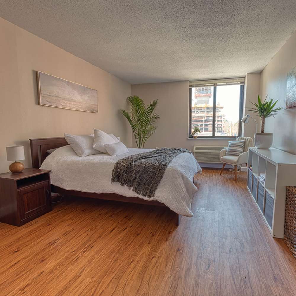 Bedroom with comfortable bed at Del Coronado Apartments in St. Louis,Missouri