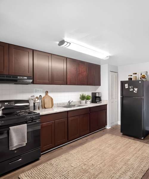 Kitchen with black appliances near Pleasant View Townhomes in Baltimore, Maryland