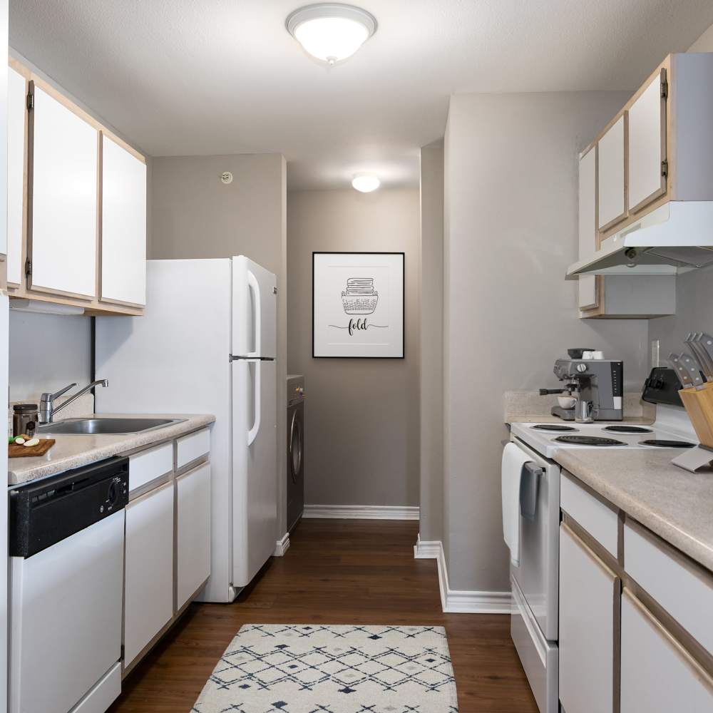 White appliances of modern kitchen at Vida Apartments in St. Charles, Missouri