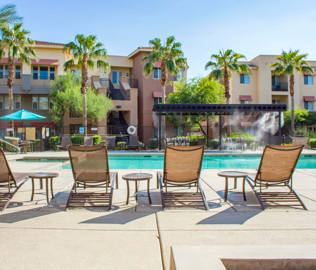 Chaise lounge chairs next to the pool at The Residences at Stadium Village in Surprise, Arizona