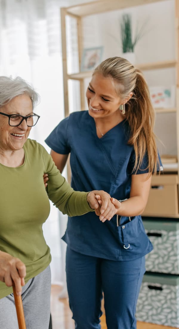 Caretaker assisting a resident walk at Living Care Lifestyles in Seattle, Washington