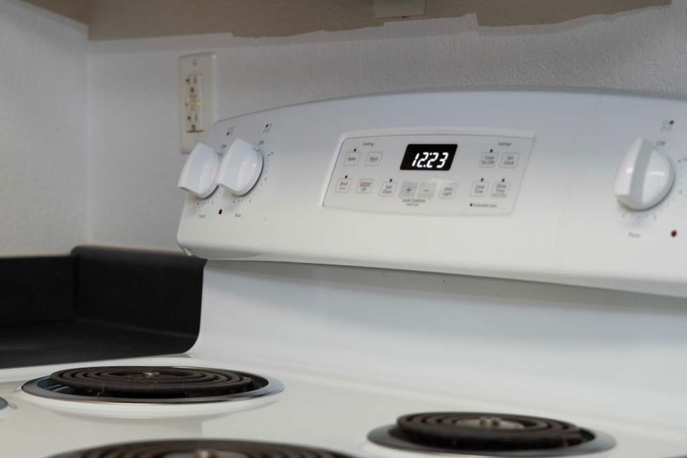 Kitchen with white appliances at Hardin Terrace in Jefferson, Georgia