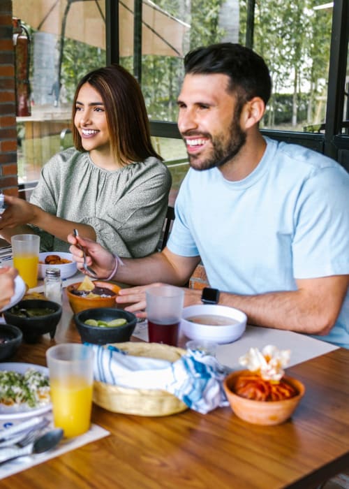 Group of friends dining outside near The Fredd Townhomes in San Antonio, Texas