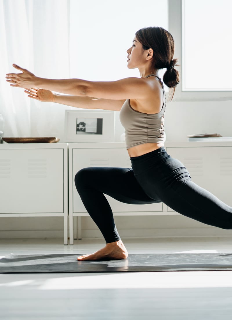 Resident doing yoga at Marquis at Stonebriar in Frisco, Texas