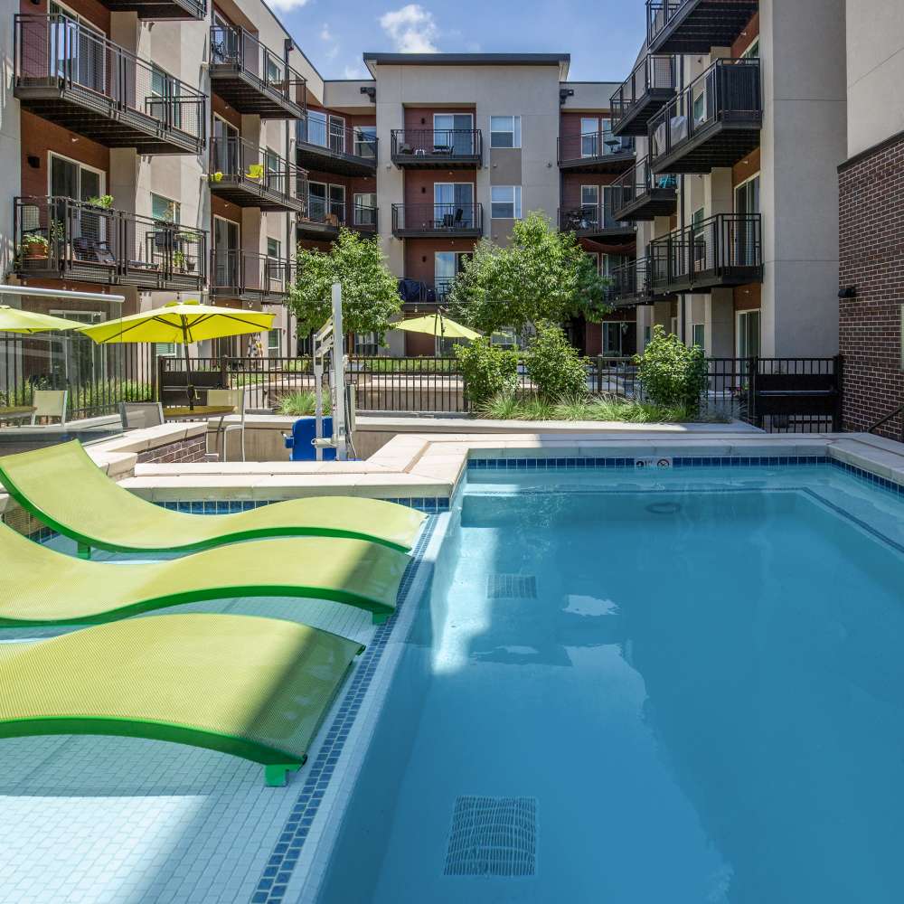 Community swimming pool with view of apartment builing at Park Place Olde Town Apartments in Arvada, Colorado