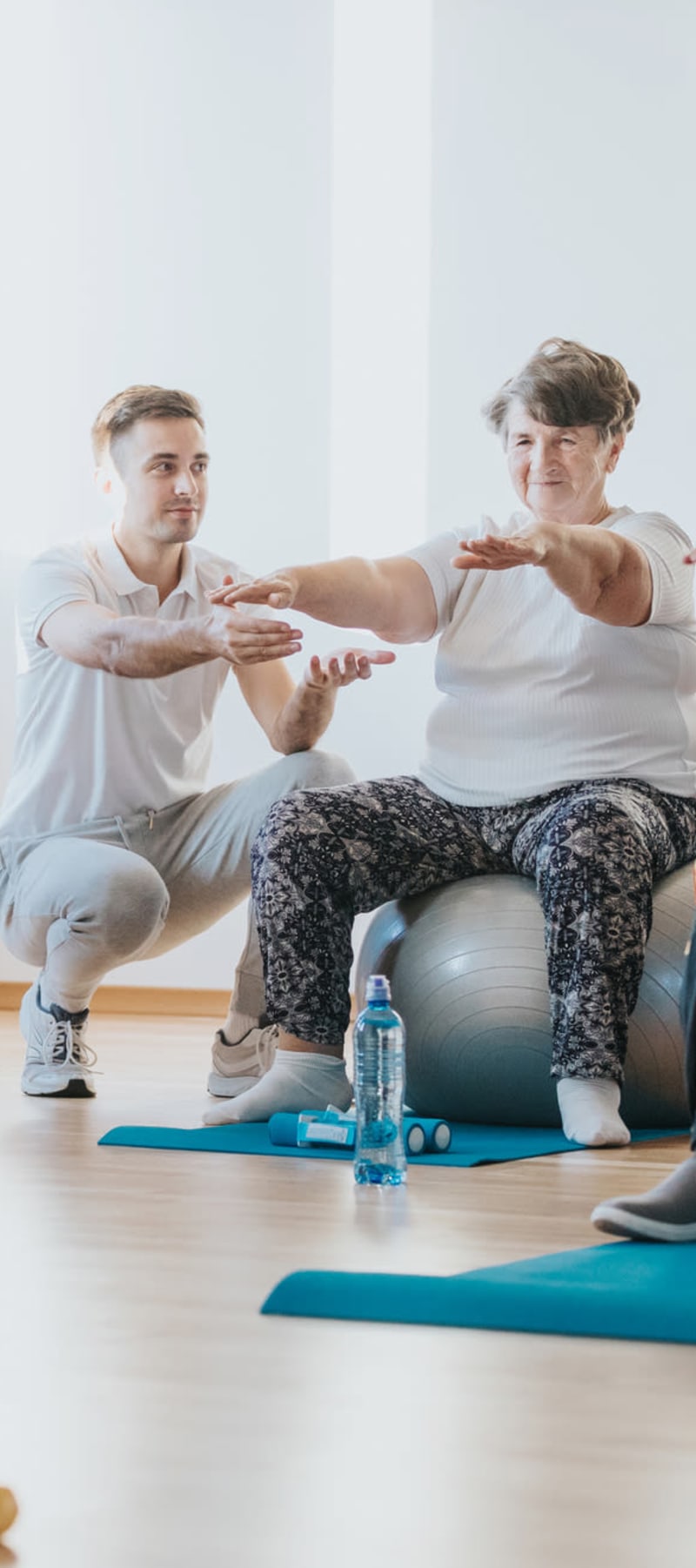 Resident working with a personal trainer at Geneva Lake Manor in Lake Geneva, Wisconsin