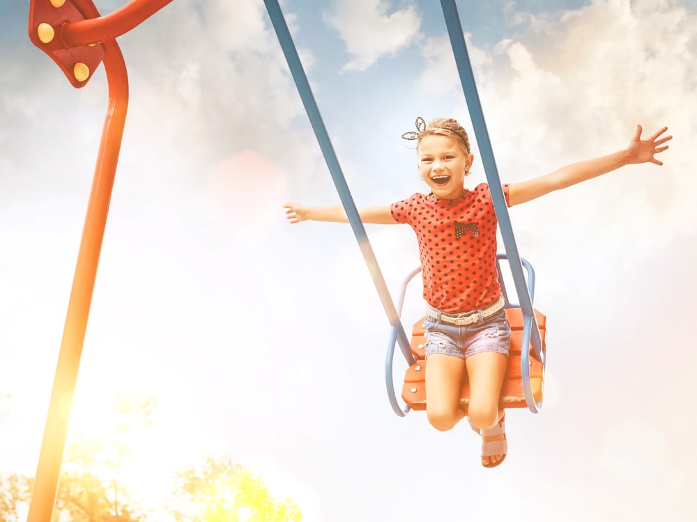 Kid on a swing at Cyrene at Estrella in Goodyear, Arizona