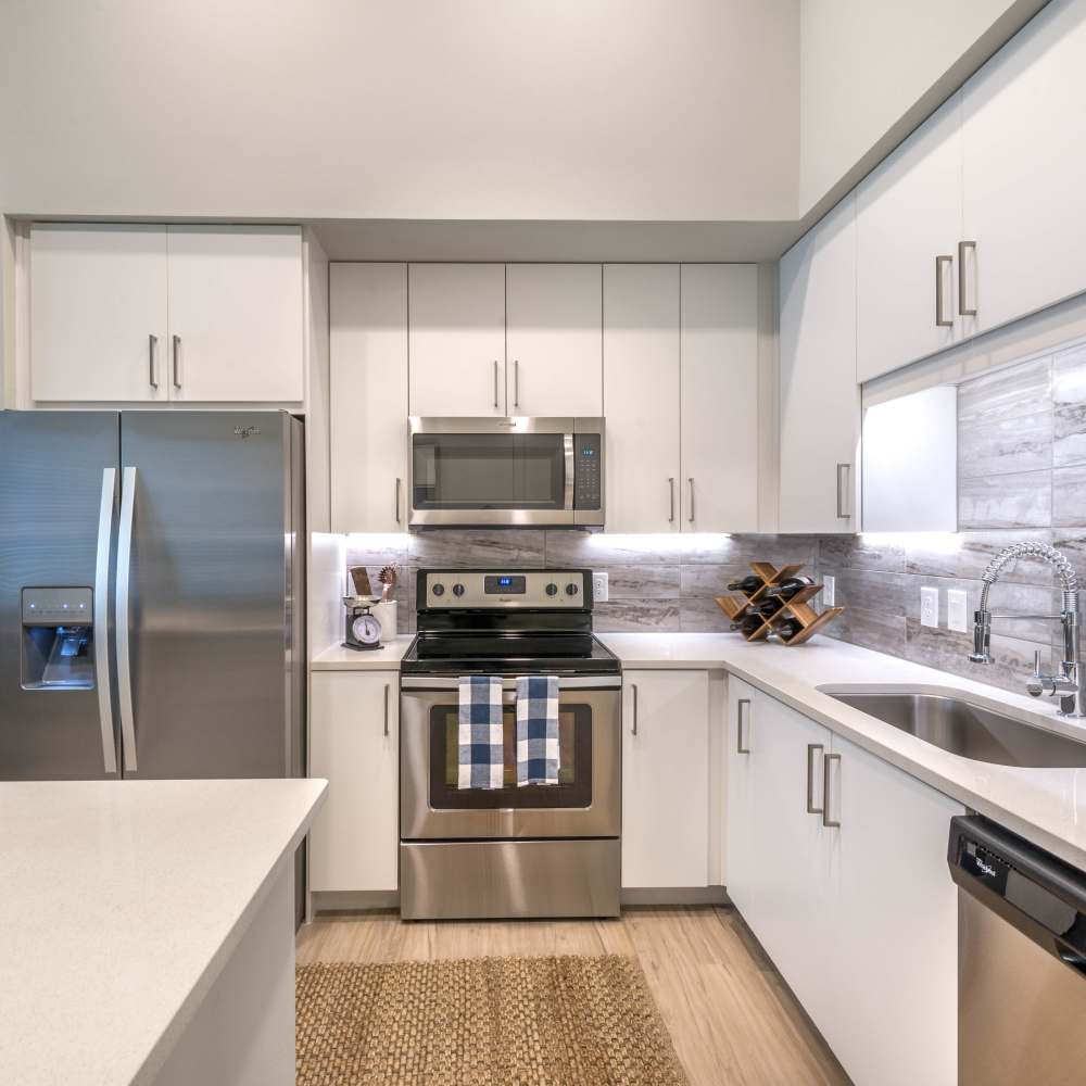 Energy-efficient appliances and white granite countertops at Hall Street Flats in Dallas, Texas