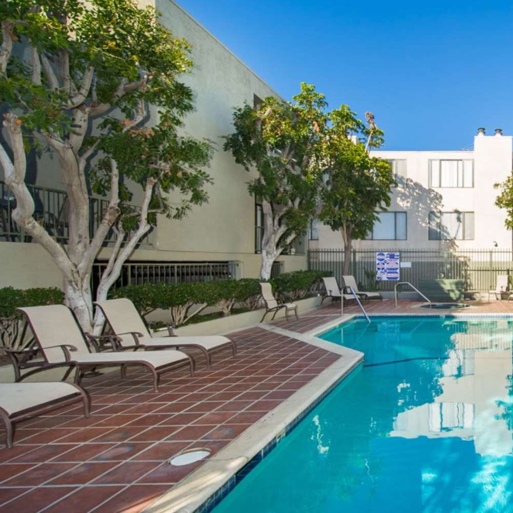 High-end swimming pool with lounge chairs at Encino Crest Apartments in Encino, California