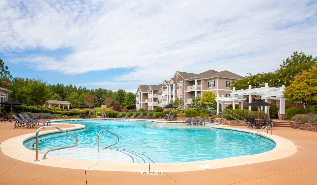 Sparkling swimming pool with lounge chairs at Madison Park in Madison, Alabama