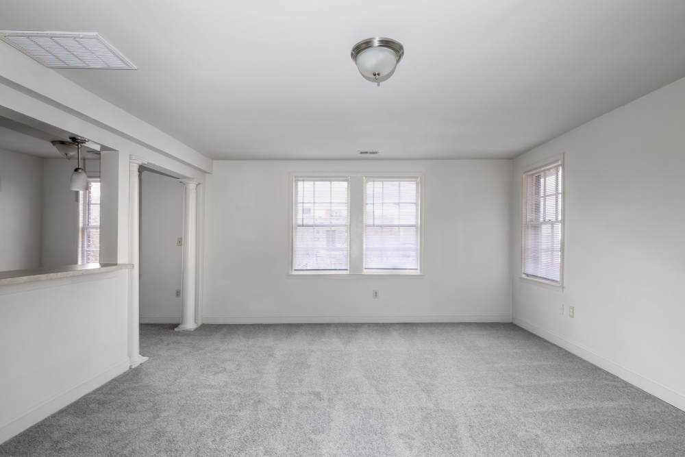 Unfurnished living room with carpet flooring at Dundalk Village in Dundalk, Maryland