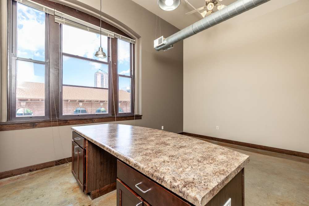 City skyline visible through large windows at Rumely Lofts in Des Moines, Iowa