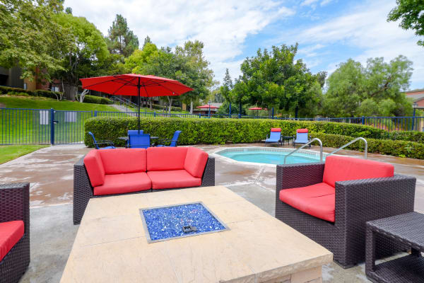 Outdoor fire pit and pool-side lounge at Presidio at Rancho Del Oro in Oceanside, California