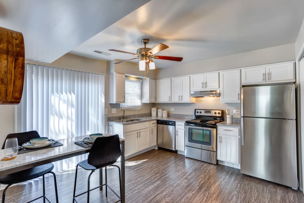 Kitchen with a ceiling fan and back porch access at Aspen Place in Aurora, Illinois