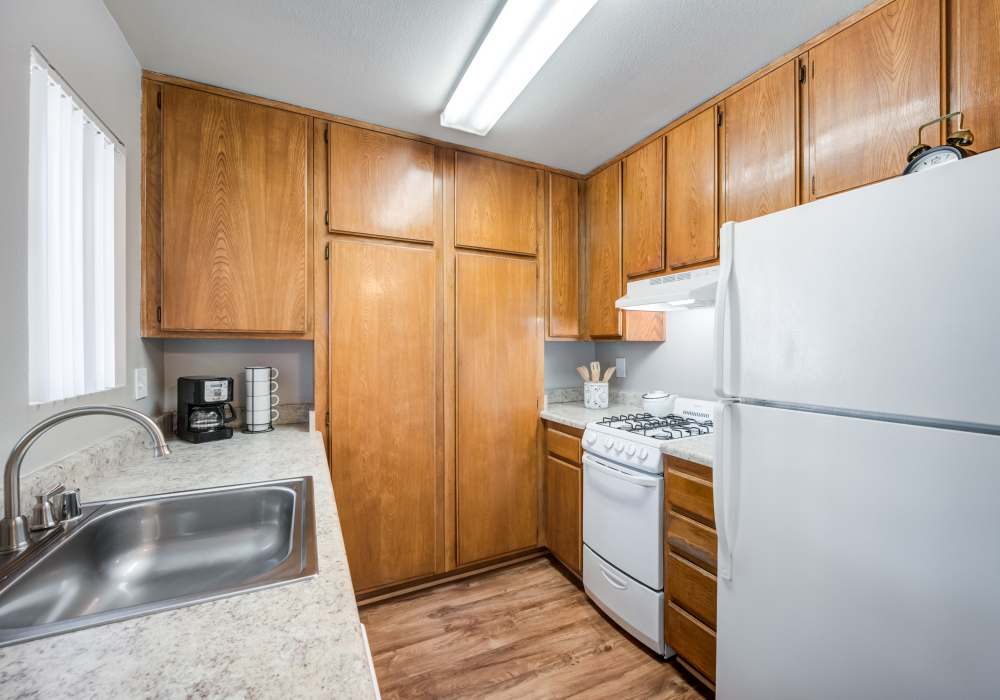 Well-equipped kitchen with custom wooden cabinetry at The Villas at Rowland Heights in Rowland Heights, California 