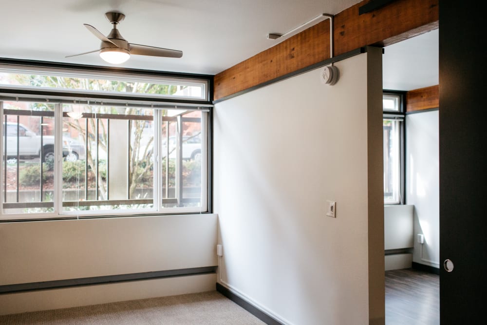 Room with ceiling fan and double pane window at MOD Apartments in Seattle, Washington