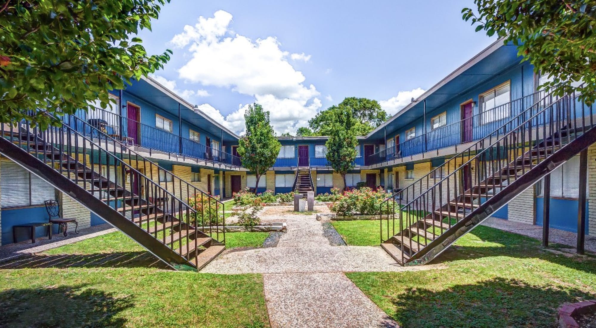 Wonderful courtyard with grass and stairs leading to units at The Station in Houston, Texas