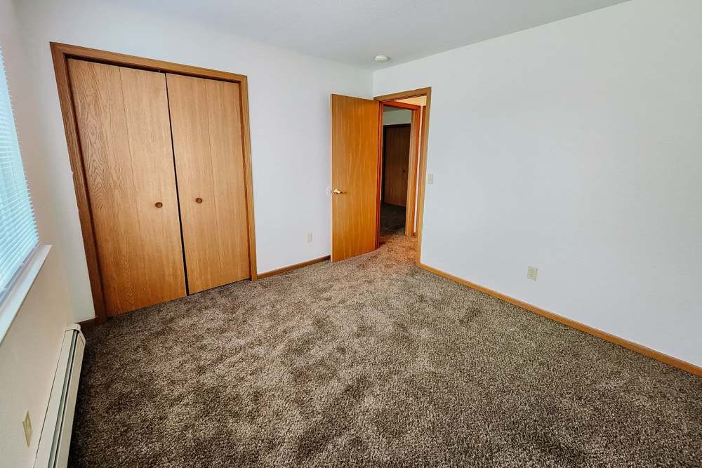 Bedroom with a closet at Rivercrest Apartments in Croswell, Michigan