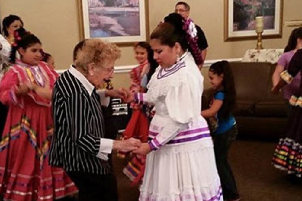 A resident enjoying a cultural dance event at Peachtree Village Retirement Community in Roswell, New Mexico. 