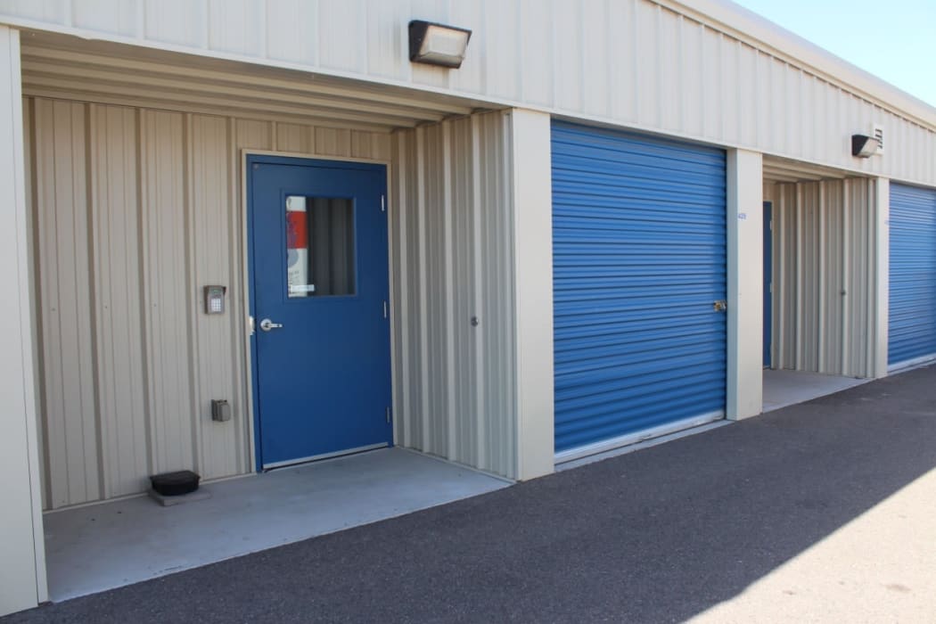 outdoor blue door with floodlight above it at Tolleson Self Storage in Tolleson, Arizona