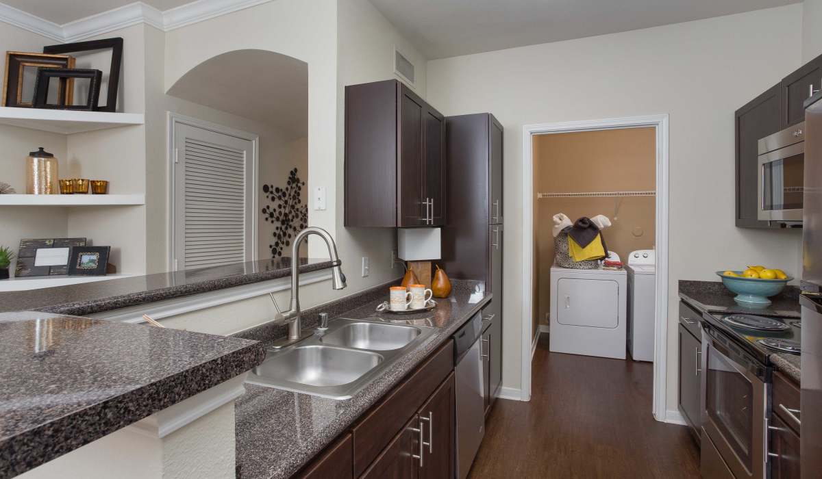 Kitchen with cabinets and sink at Whispering Pines Ranch in The Woodlands, Texas