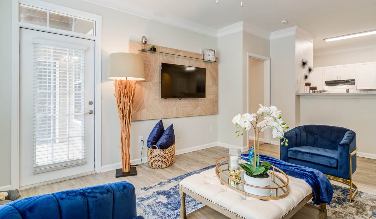 Living room with couch, TV and ceiling fan at Legacy Ridge in Atlanta, Georgia