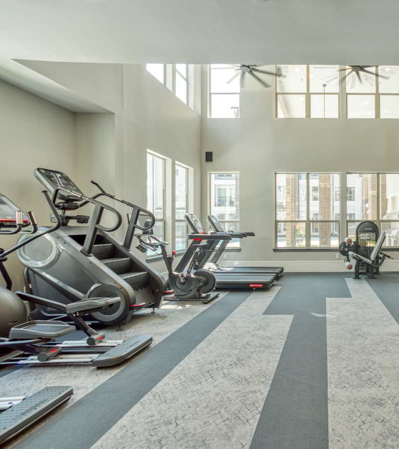 Fitness equipment in a bright room at Dakota at Shepherd in Houston, Texas