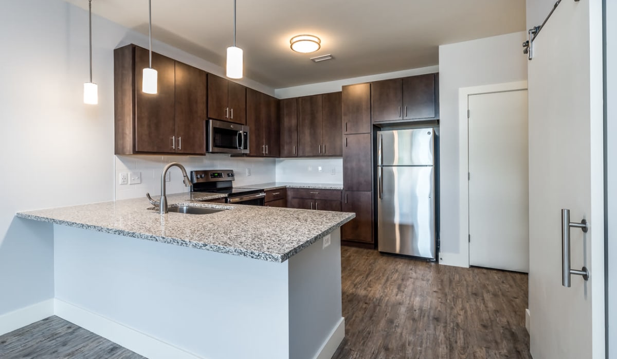 Kitchen with dark wood cabinets at Echelon Luxury Apartments in Cincinnati, Ohio