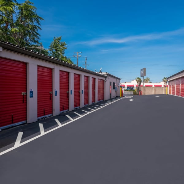 Accessible outdoor storage units with red doors at StorQuest Express Self Service Storage in Sacramento, California