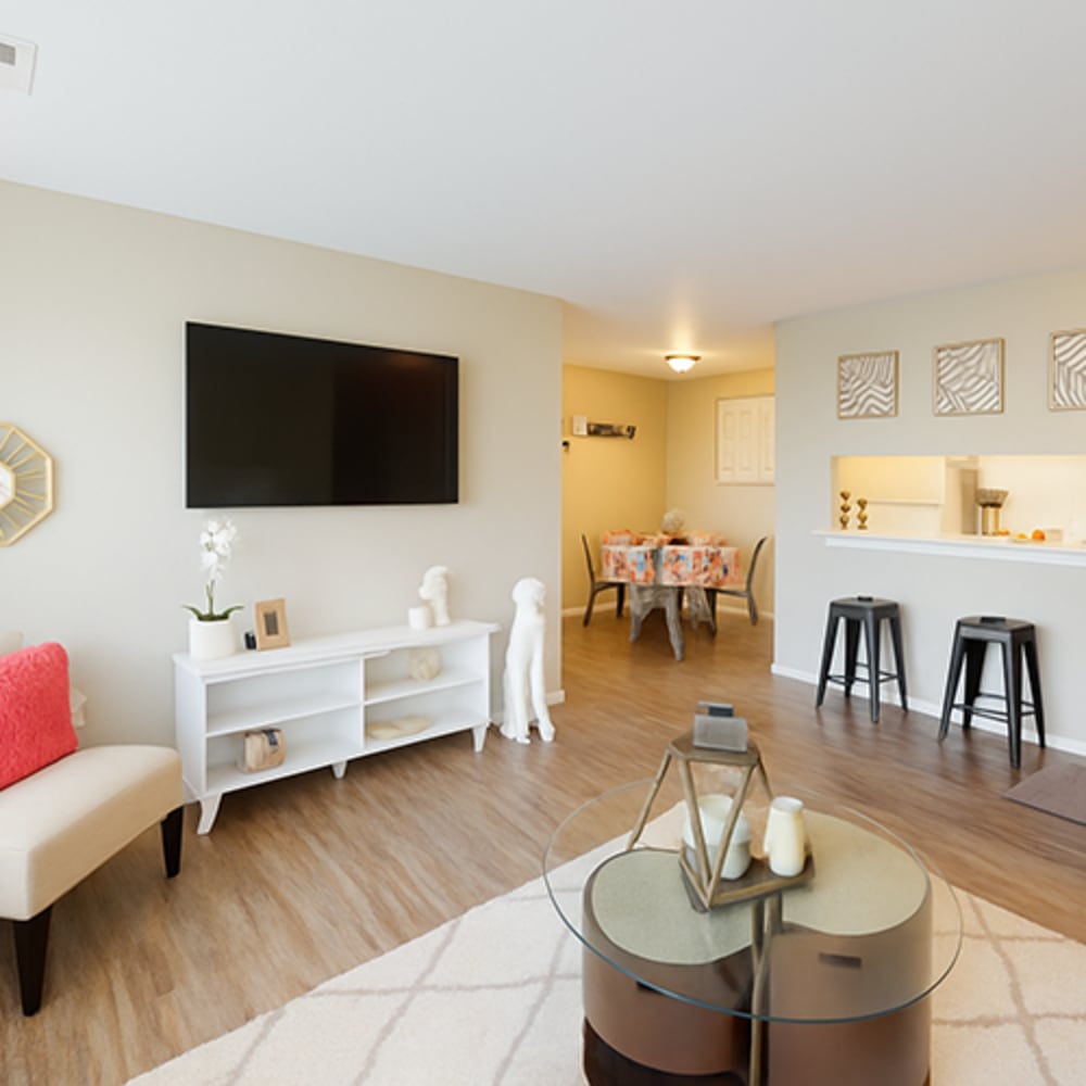 Living room with a large TV at Central Park Place in Grand Rapids, Michigan