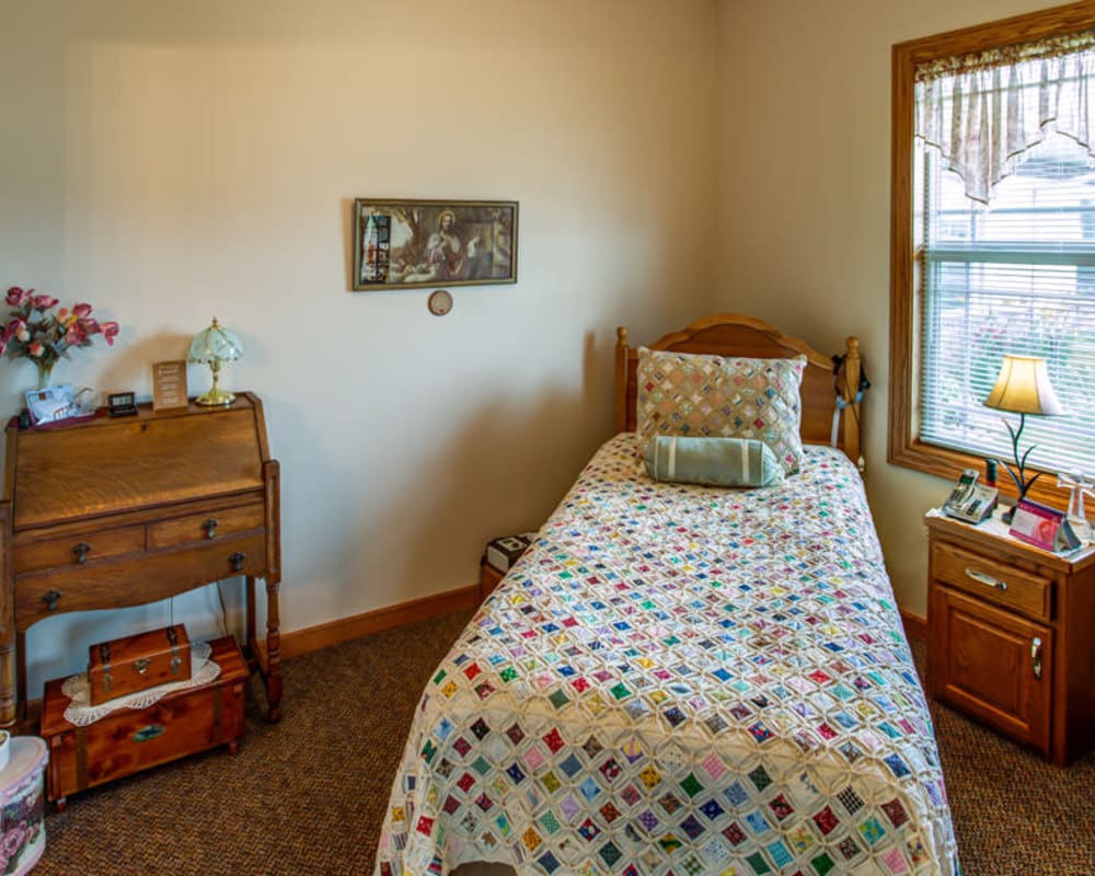 Cozy resident bedroom at Addington Place of Carroll in Carroll, Iowa.