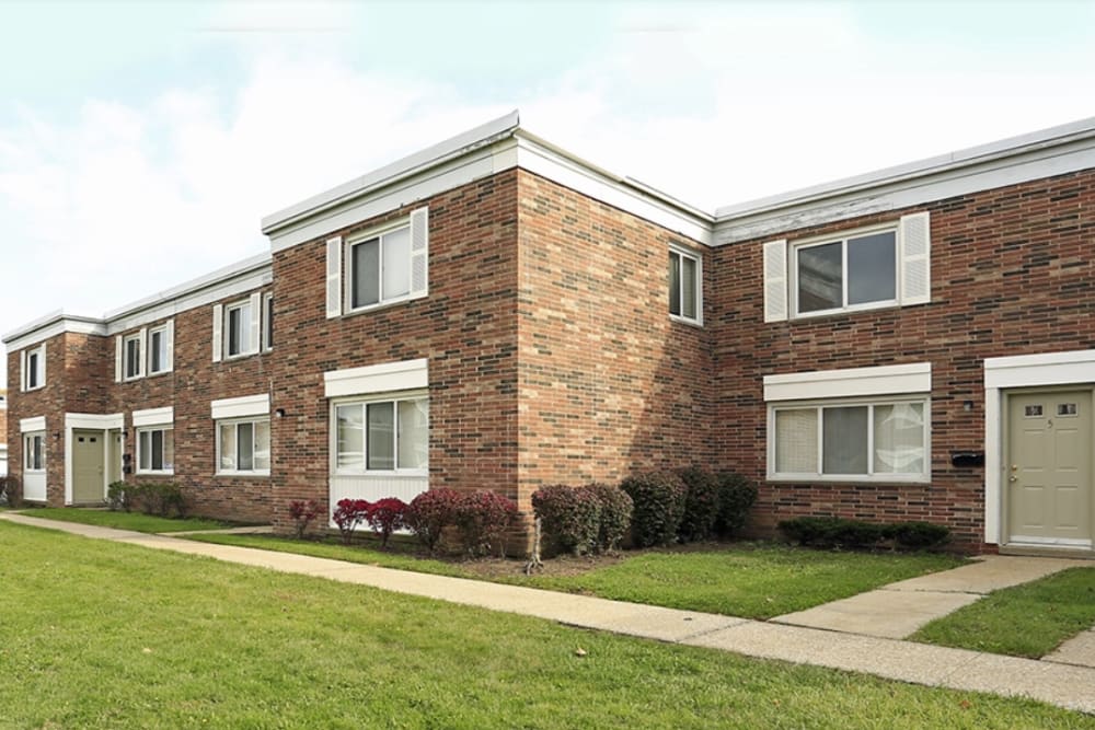 Garden style building exterior with landscaped walkway at Clarkwood Greens in Warrensville Heights, Ohio
