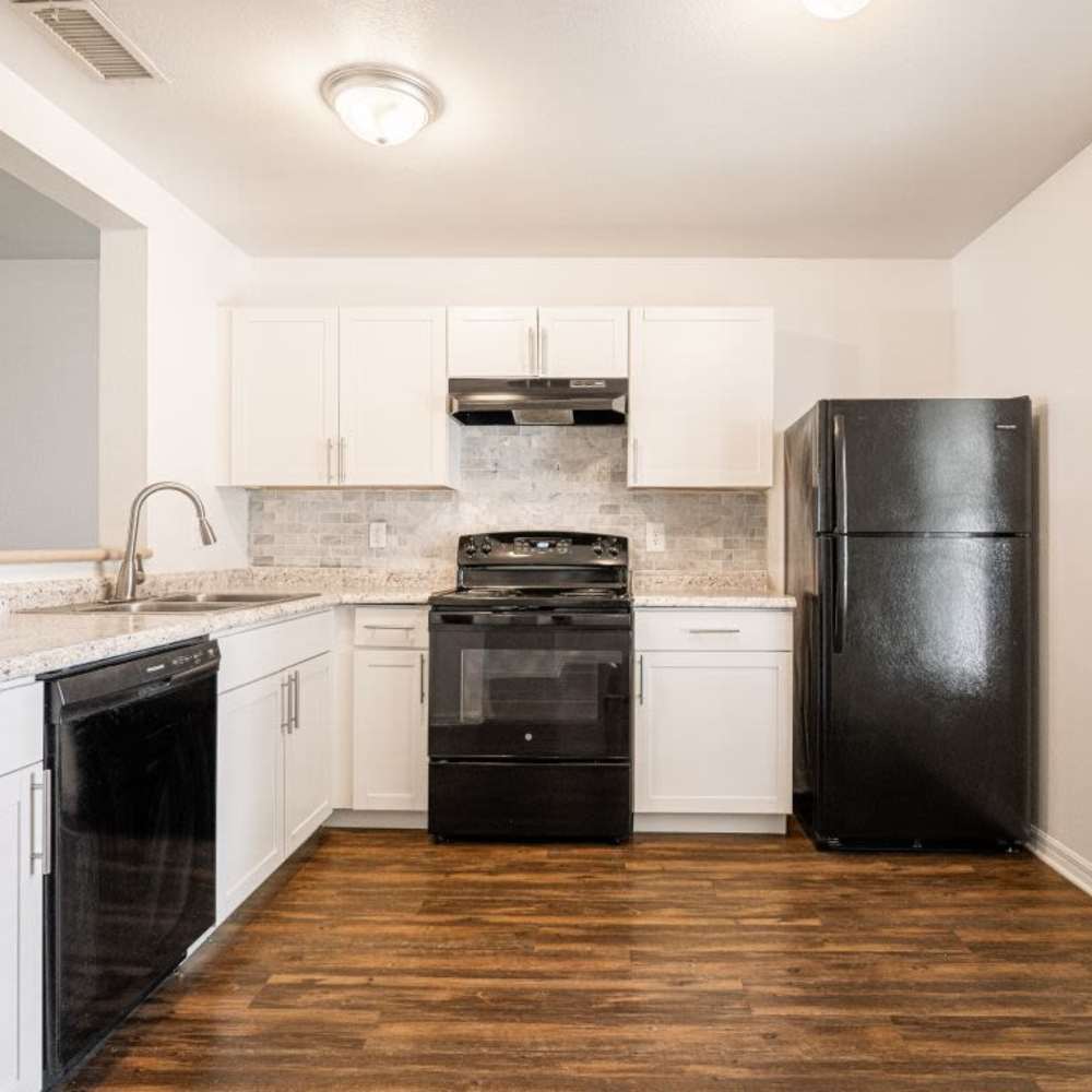 Modern kitchen with wooden cabinets at Cypress Commons in Wildwood, Florida