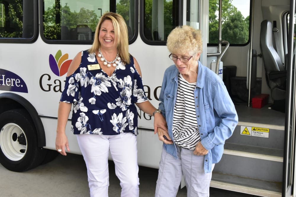 A resident and caregiver in front of a transport van at Garden Place Columbia in Columbia, Illinois. 