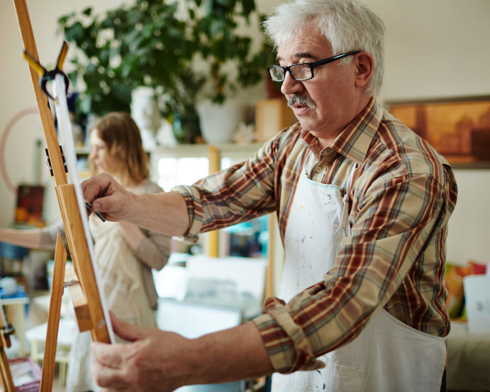 Seniors painting at Seven Lakes Memory Care in Loveland, Colorado