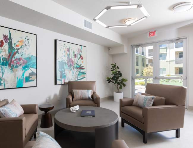 Bright, modern living room with stylish artwork and cozy seating at Antioch Family & Senior Apartments in Antioch, California