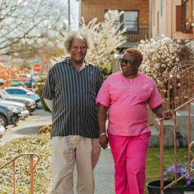 Independent living couple out for a stroll through the neighborhood near their home at a community by Cascade Senior Living Services