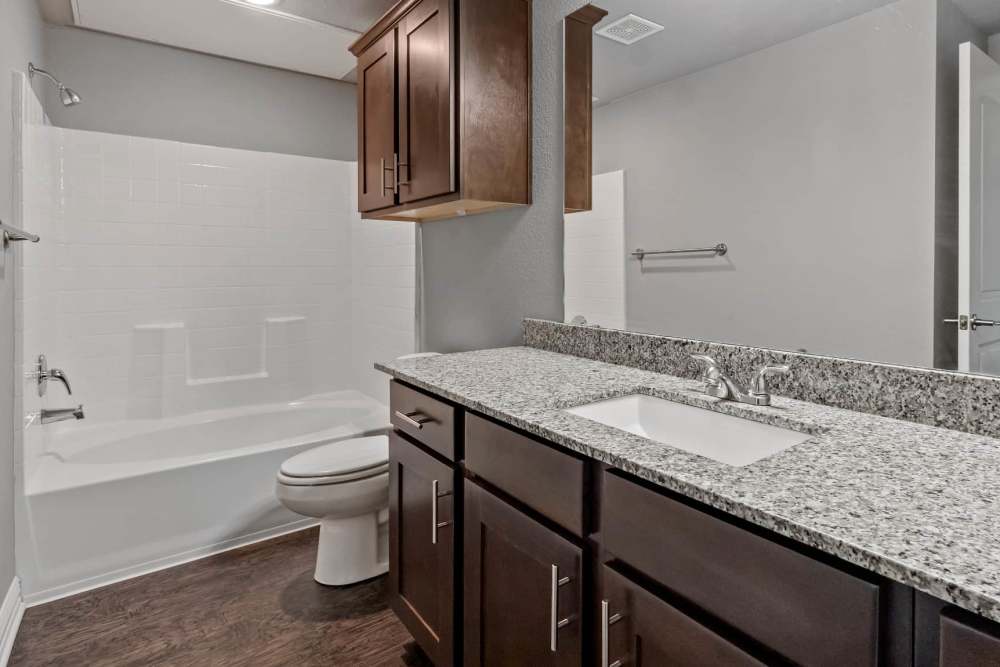 Granite countertops and cutom cabinetry in the bathroom at Pine Creek in Paris, Texas