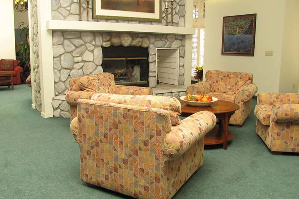 Cozy fireplace seating in the common area at Hilltop Commons Senior Living in Grass Valley, California