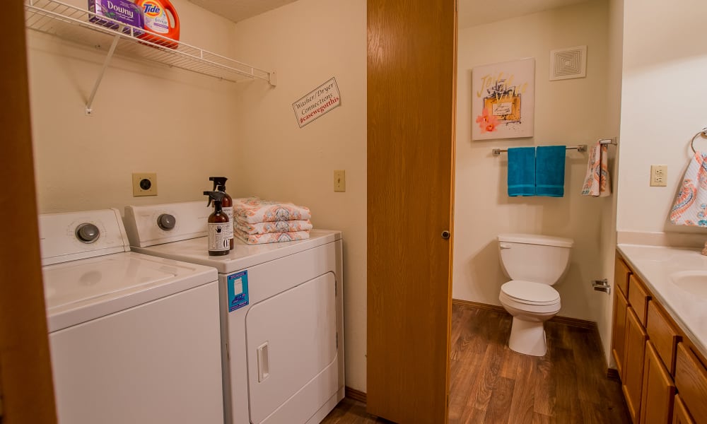 Spacious and clean model bathroom with washer and dryer at Huntington Park Apartments in Wichita, Kansas